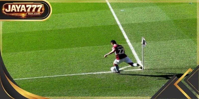 The assistant referee stands ready at the touchline as a winger drives the ball