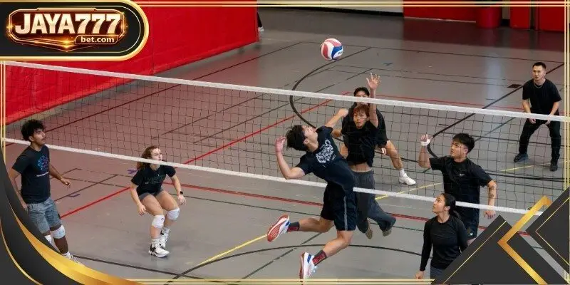 Players jump at the net to form a solid block against an incoming attack